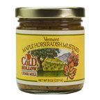 A jar of Cold Hollow Maple Horseradish Mustard with a label showing an apple tree, leaves, and a mountain range.